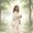 Woman with warm brown skin walking through a park in early morning light