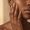Dark skin woman touching her face