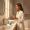  Woman at a bathroom counter with a curated skincare routine