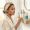  Woman looking at a simple lineup of skincare products