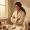 Woman evaluating her skincare products on a bathroom counter