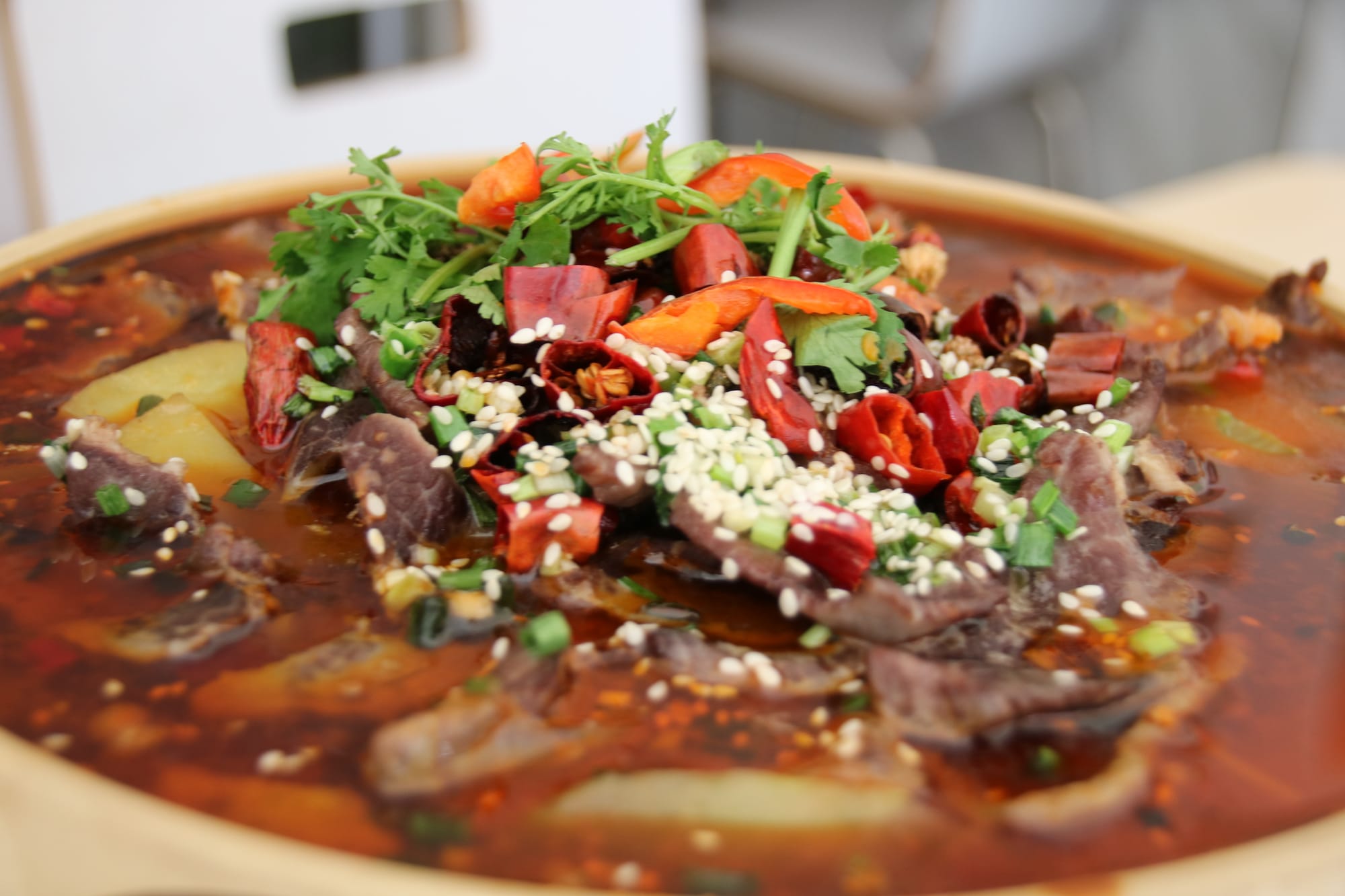 Spicy Beef hotpot with potatoes, lotus, bean sprouts and Chinese lettuce