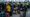 Passengers queuing in Bournemouth Airport departure hall with strike notices on check-in screens
