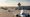 Several aircraft queue on a European airport taxiway in summer sunlight, showing busy air traffic operations.”