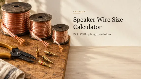 Three spools of copper speaker wire in different thicknesses with stripped ends, brass banana plugs and a wire stripper on a workbench.