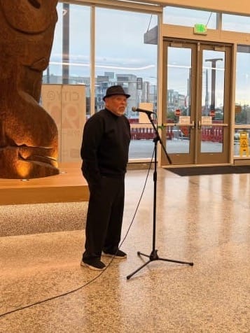 Ma speaking at a mic.