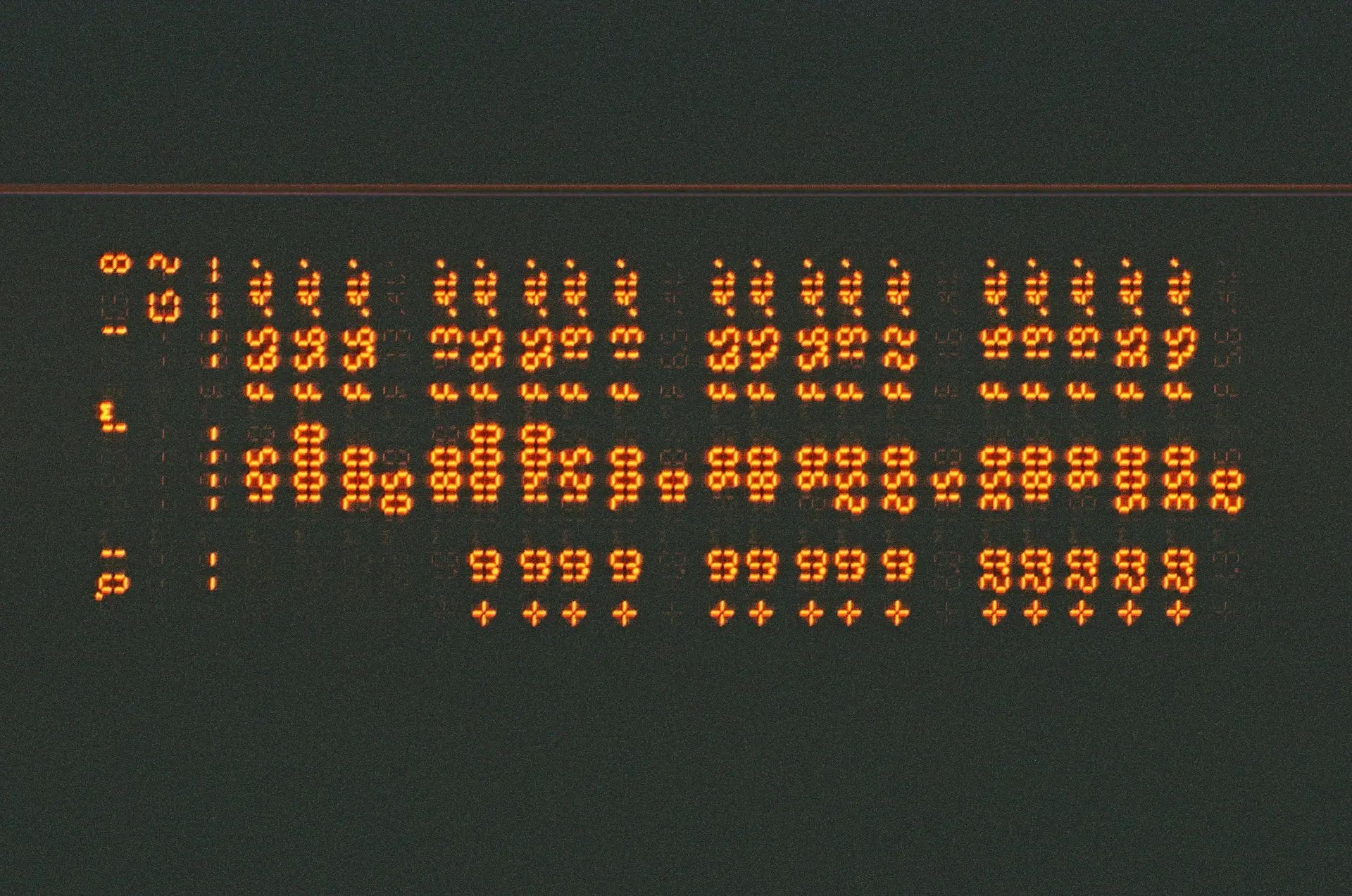 Old orange segment screen displaying a lot of numbers in a table.