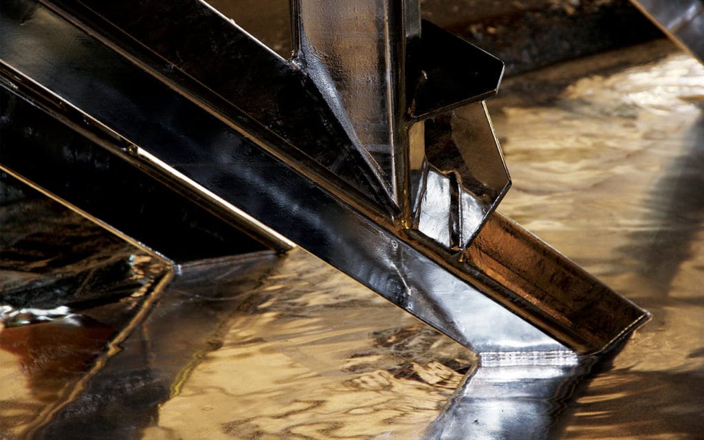 stair stringer dipping into molten zinc - galvanising