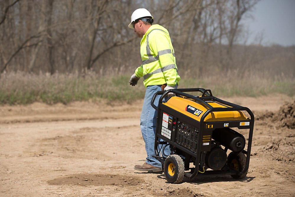 Man dragging portable generator