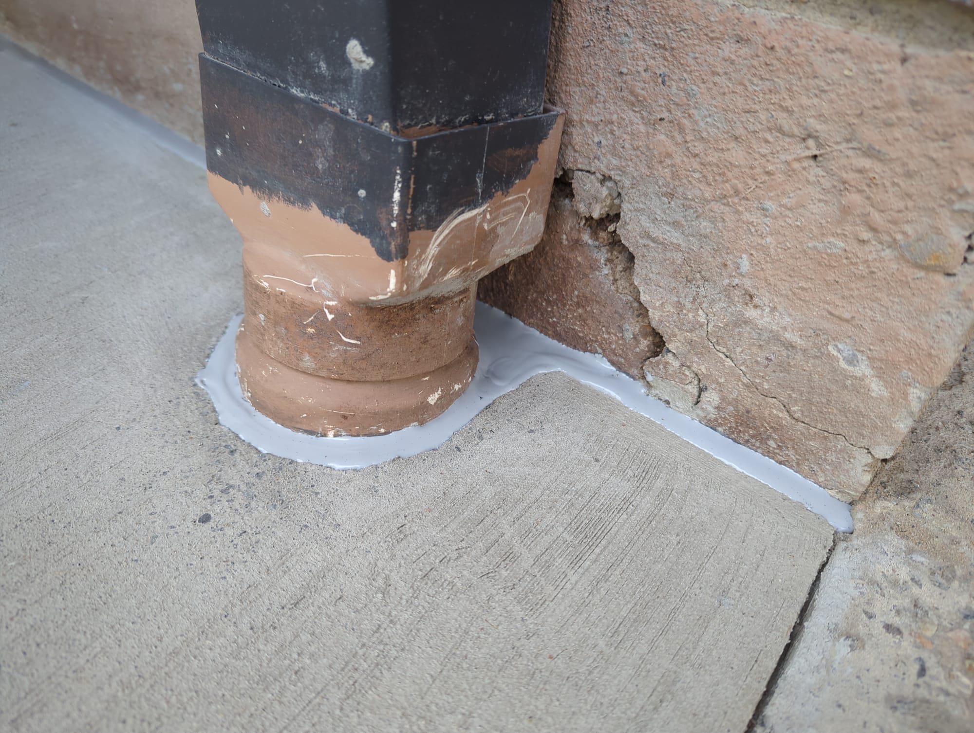 Concrete pathway and isolation joint sealant plus down pipe