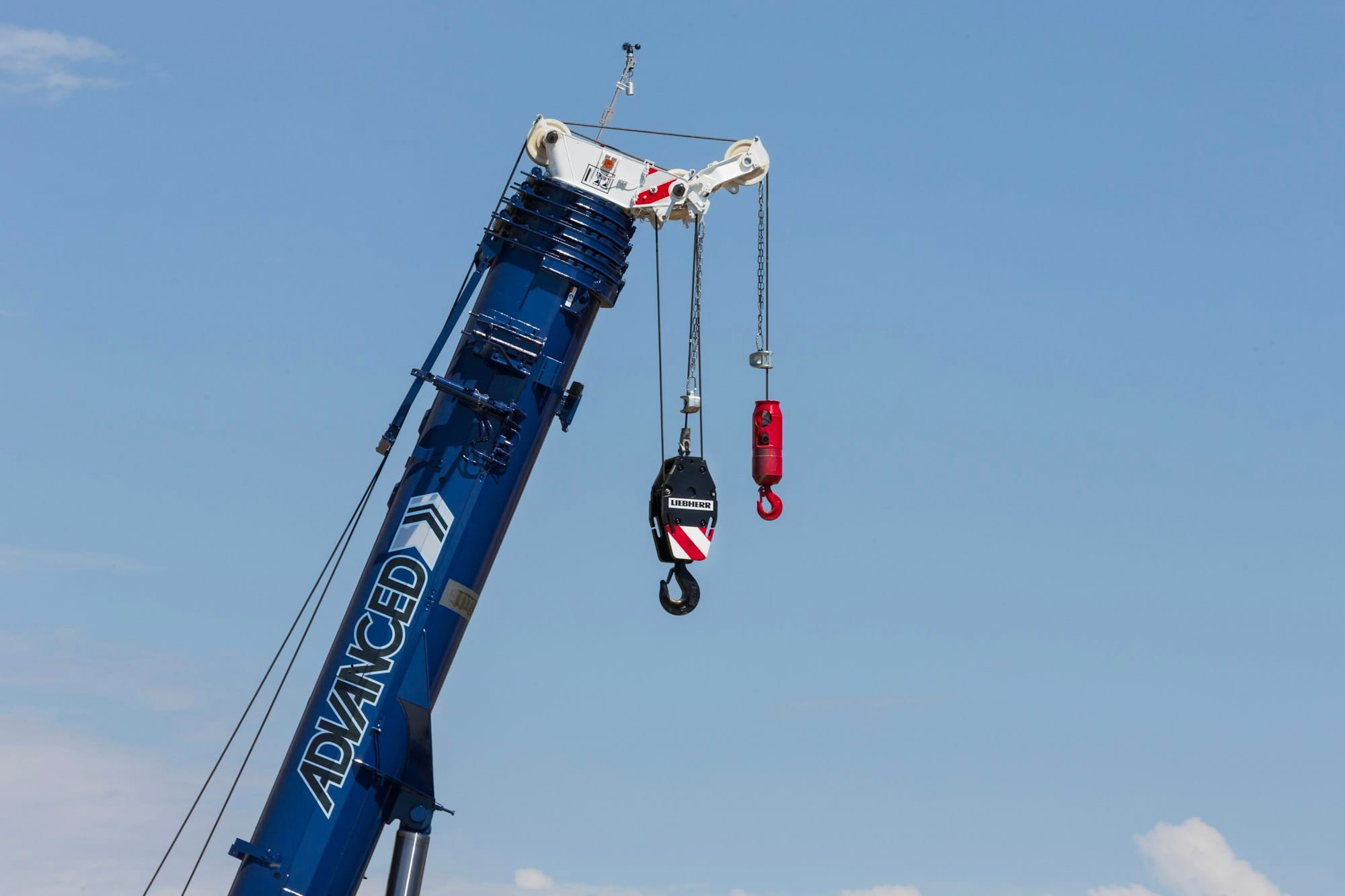 a crane is lifting a piece of equipment into the air