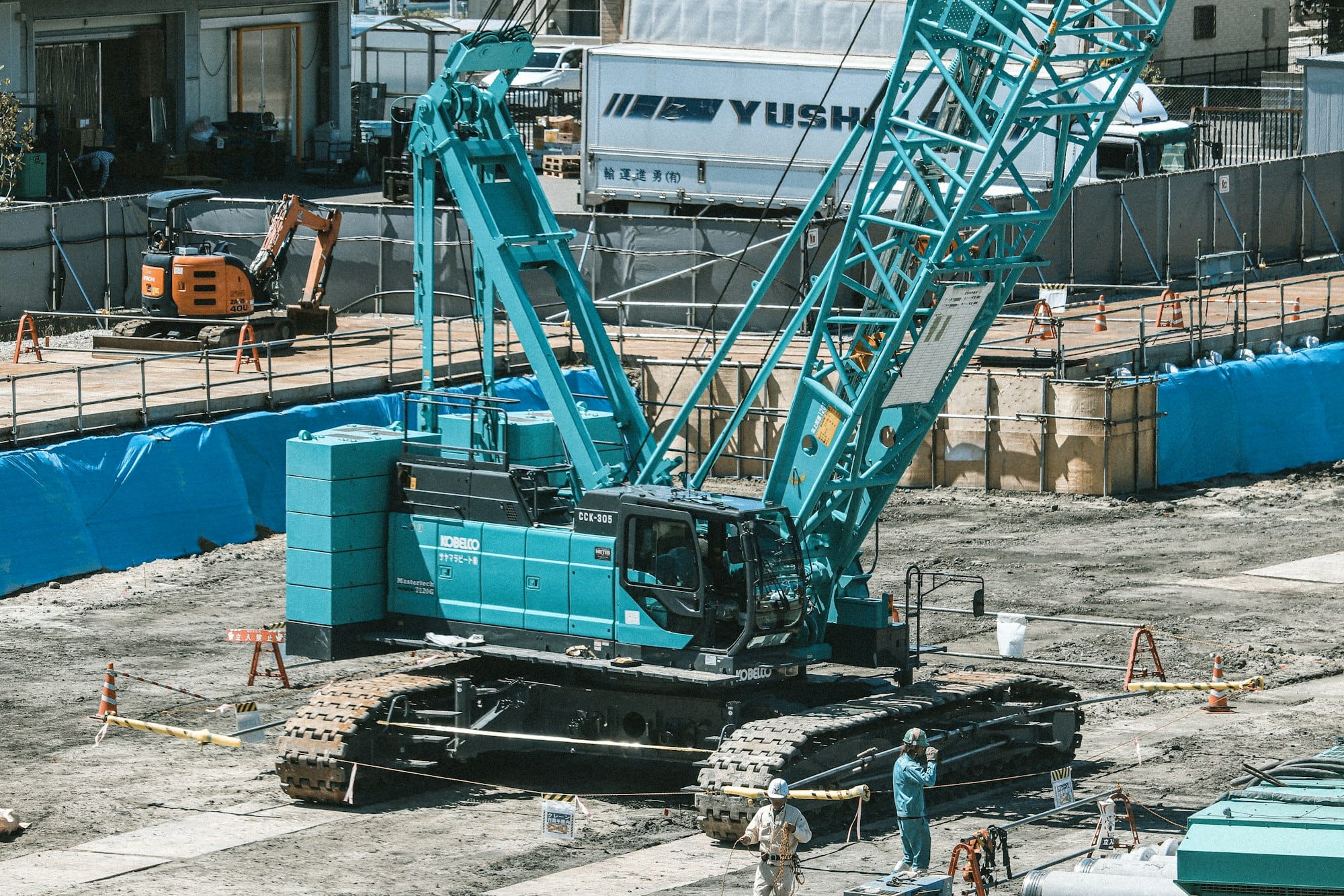 a large blue crane sitting on top of a construction site