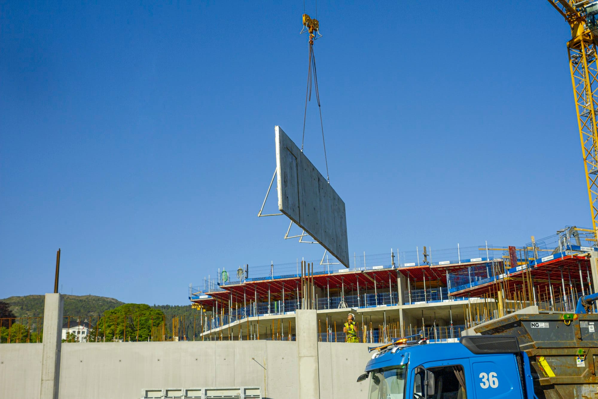 a crane is lifting a large sign onto a building