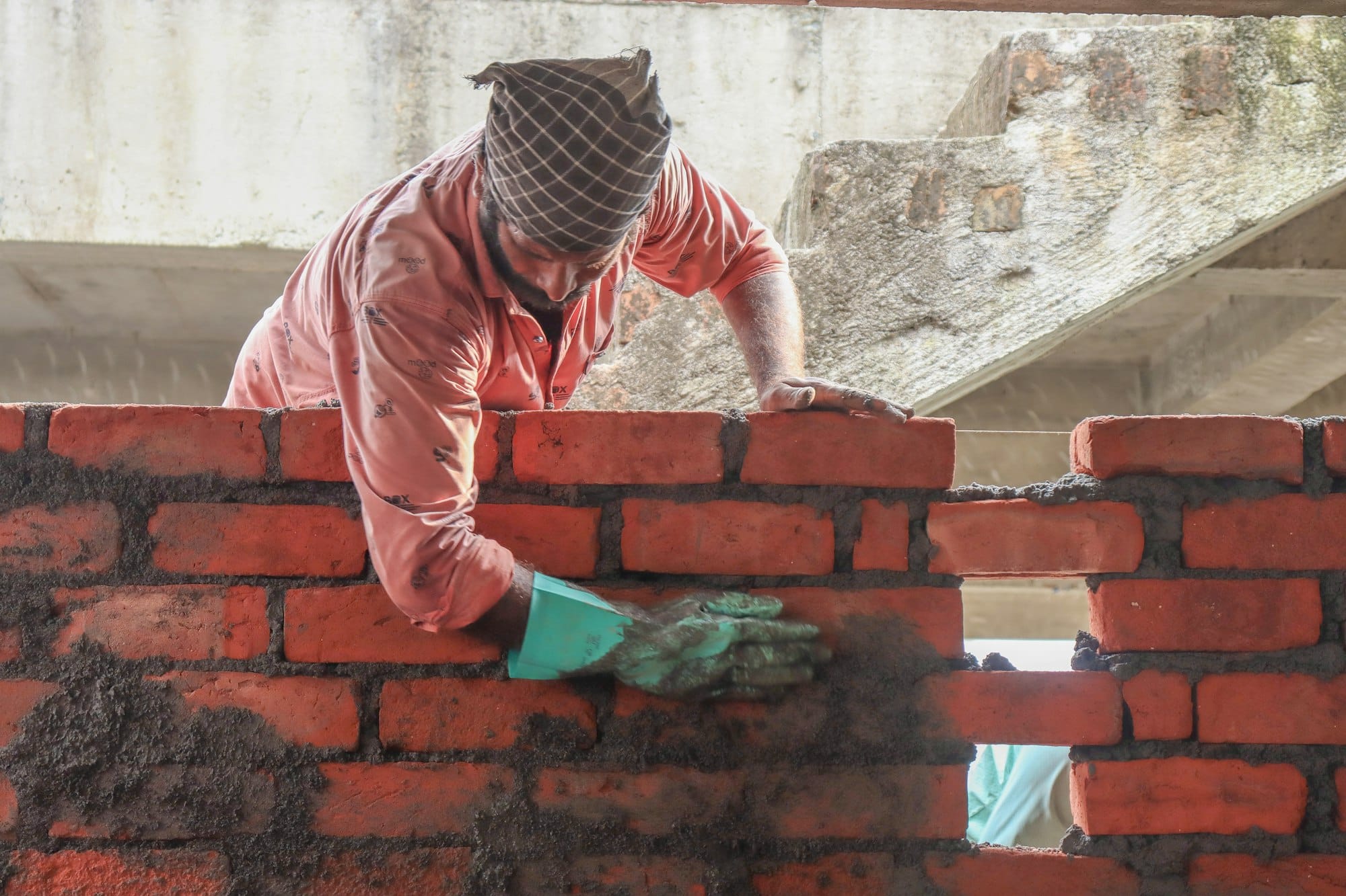 a man is working on a brick wall