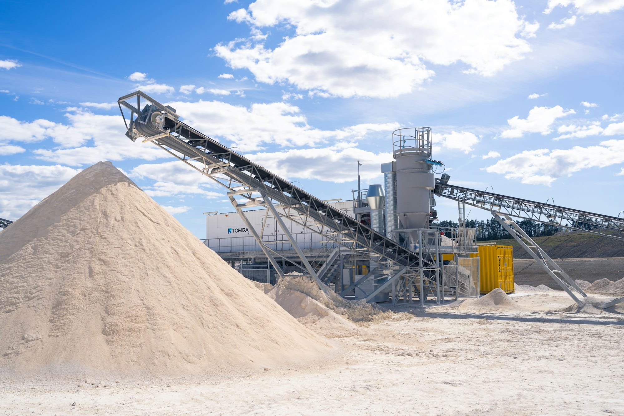 Sand processing machinery and large pile of sand