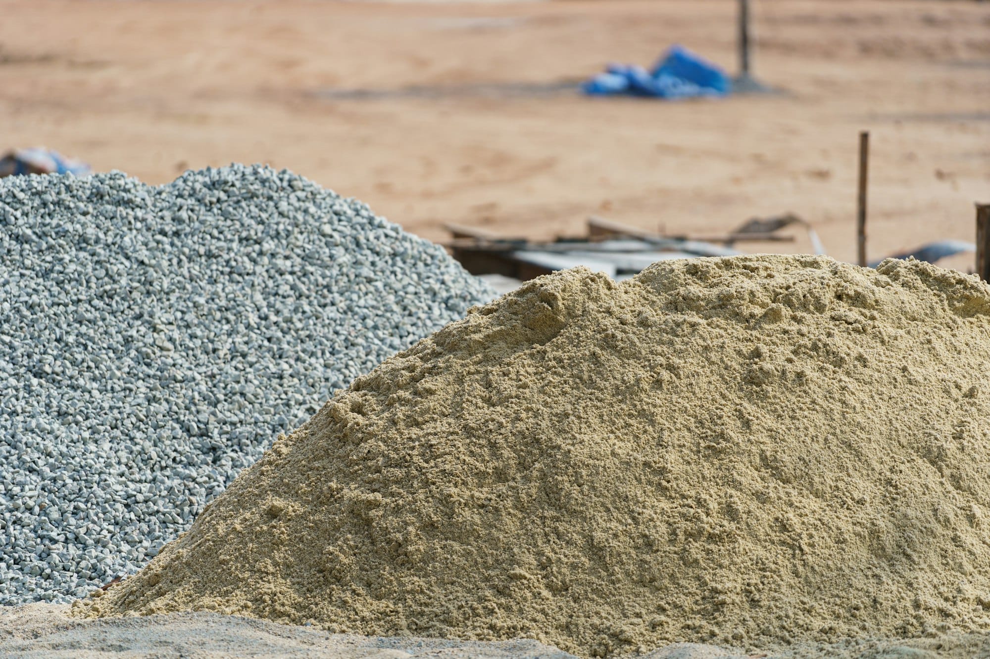 a pile of cement next to a pile of sand