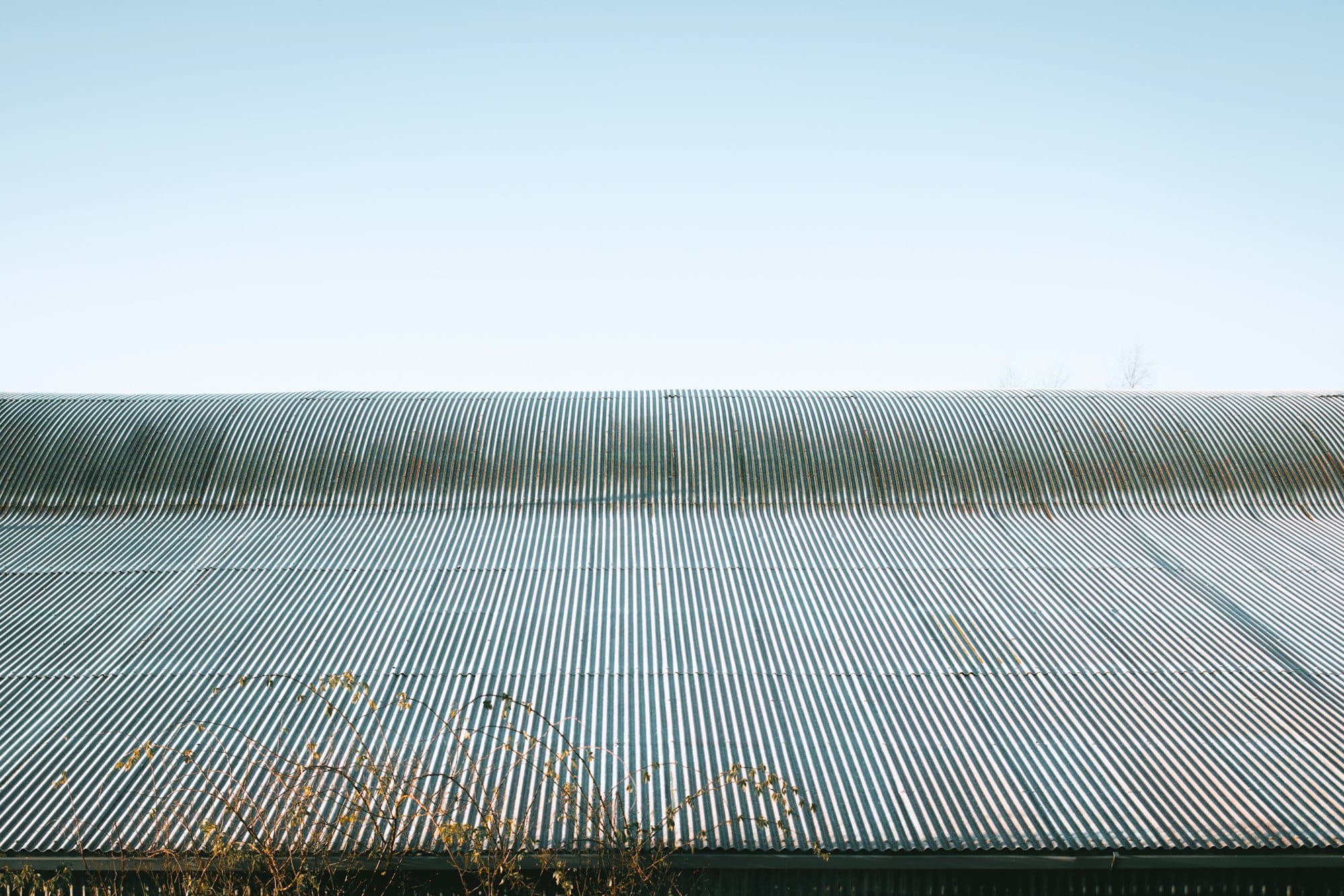 A corrugated metal roof under a clear blue sky