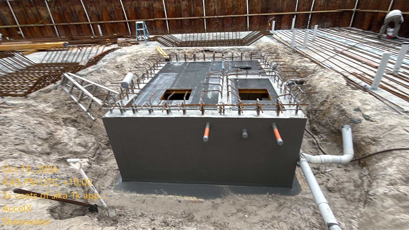 Both tanks coated, with the pipes ready for the plumber and the basement slab steel behind
