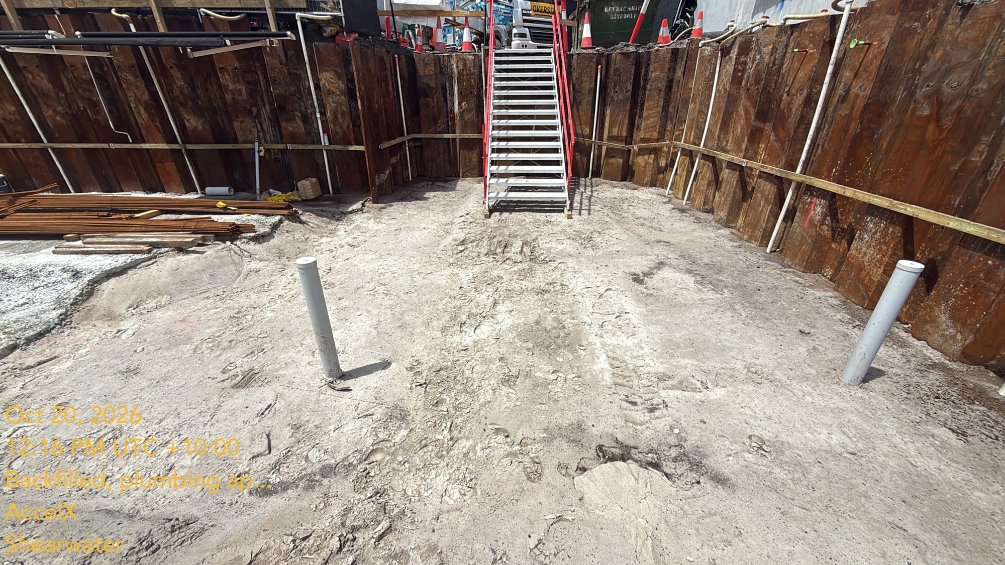 The front of the basement by the stairs, cleaned down to level with the pipes standing up, ready for blinding