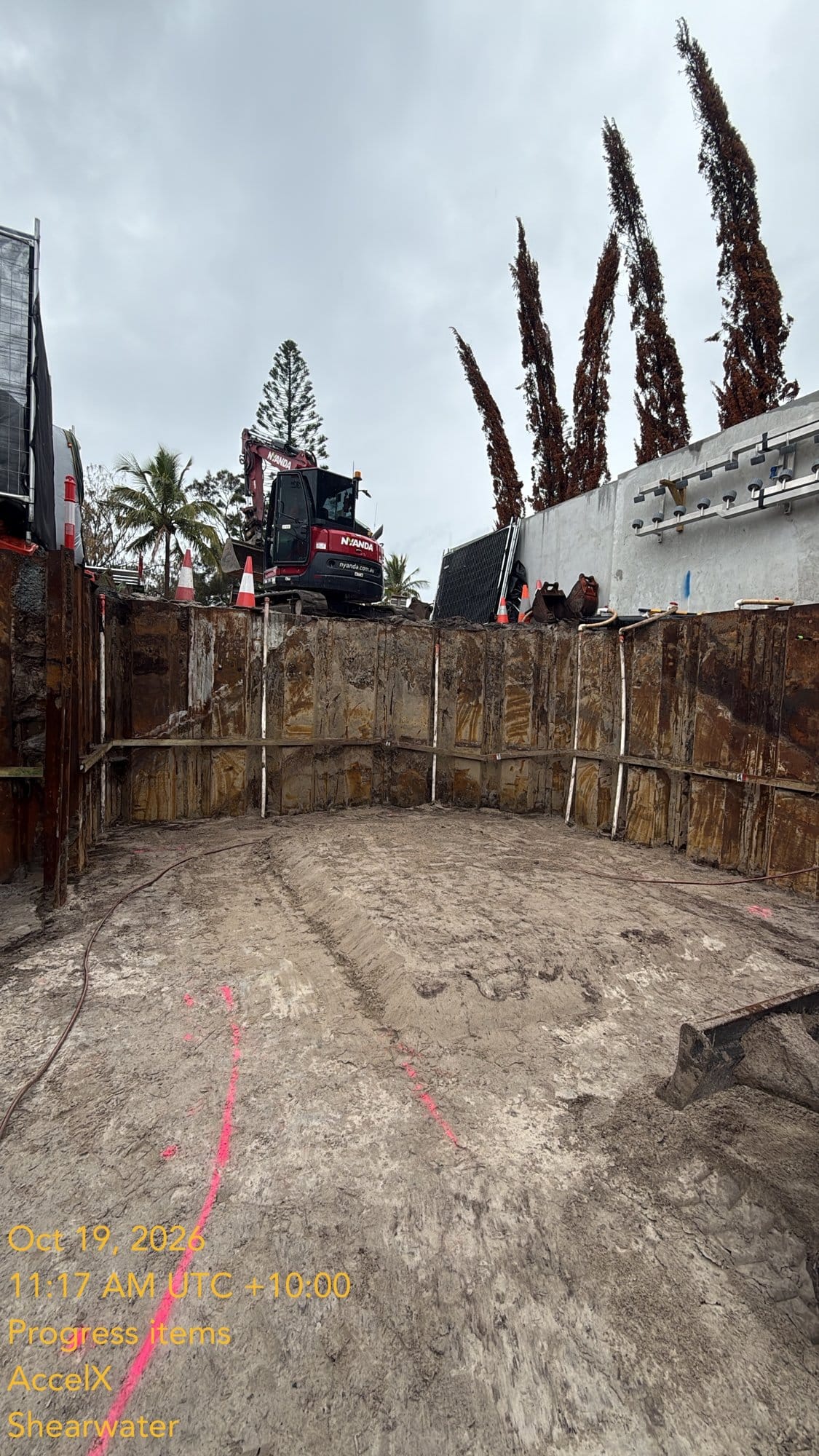 The edge thickening at the front of the site, with the 8 tonne excavator up at street level