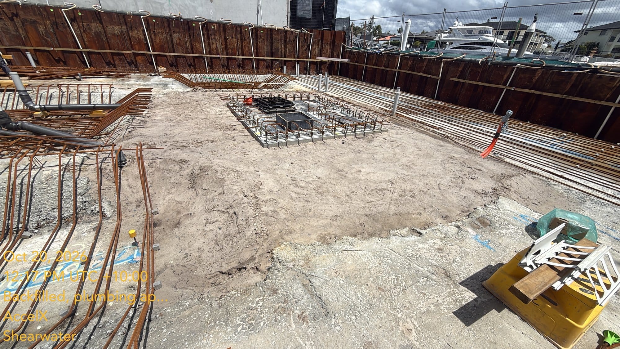 Looking across the backfilled tanks, with the bottom slab steel going in around them