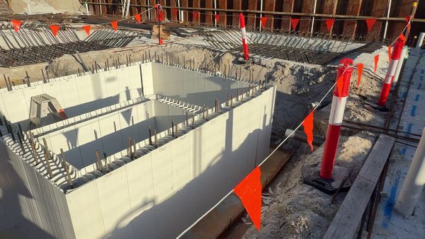 The sewer and stormwater tanks formed in white Rediwall permanent formwork, with the first layers of slab steel around them