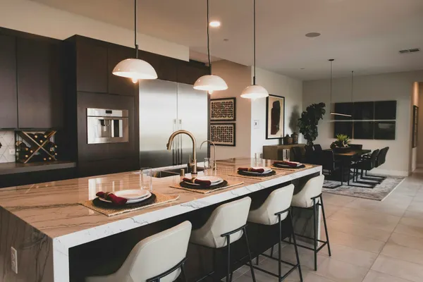 Display-style kitchen with island bench and pendant lights