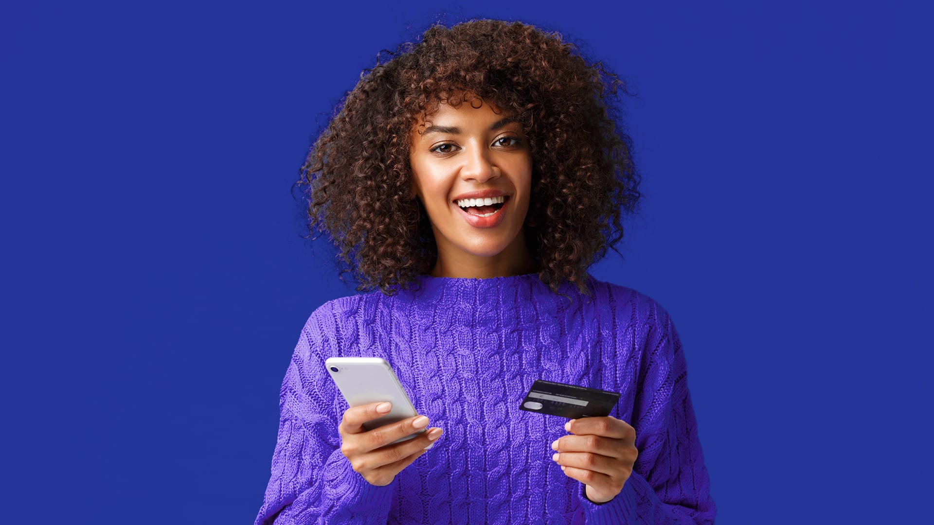 Lady with curly hairs excited about gettingher new secured credit card
