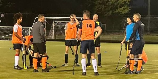 BBHC Men's 1st XI squad having a mid-session debrief  