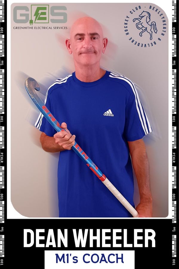Hockey coach Dean Wheeler wearing a blue top and holding a hockey stick. Logos in top corner are of BBHC and the sponsors, Greenhithe Electrical Services