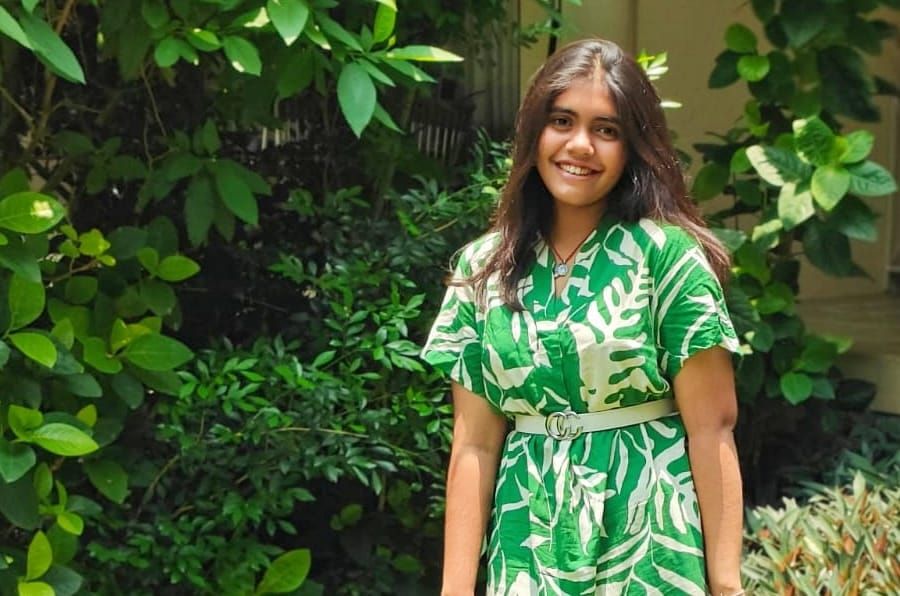 The poet enjoying her vacation in a field of greenery