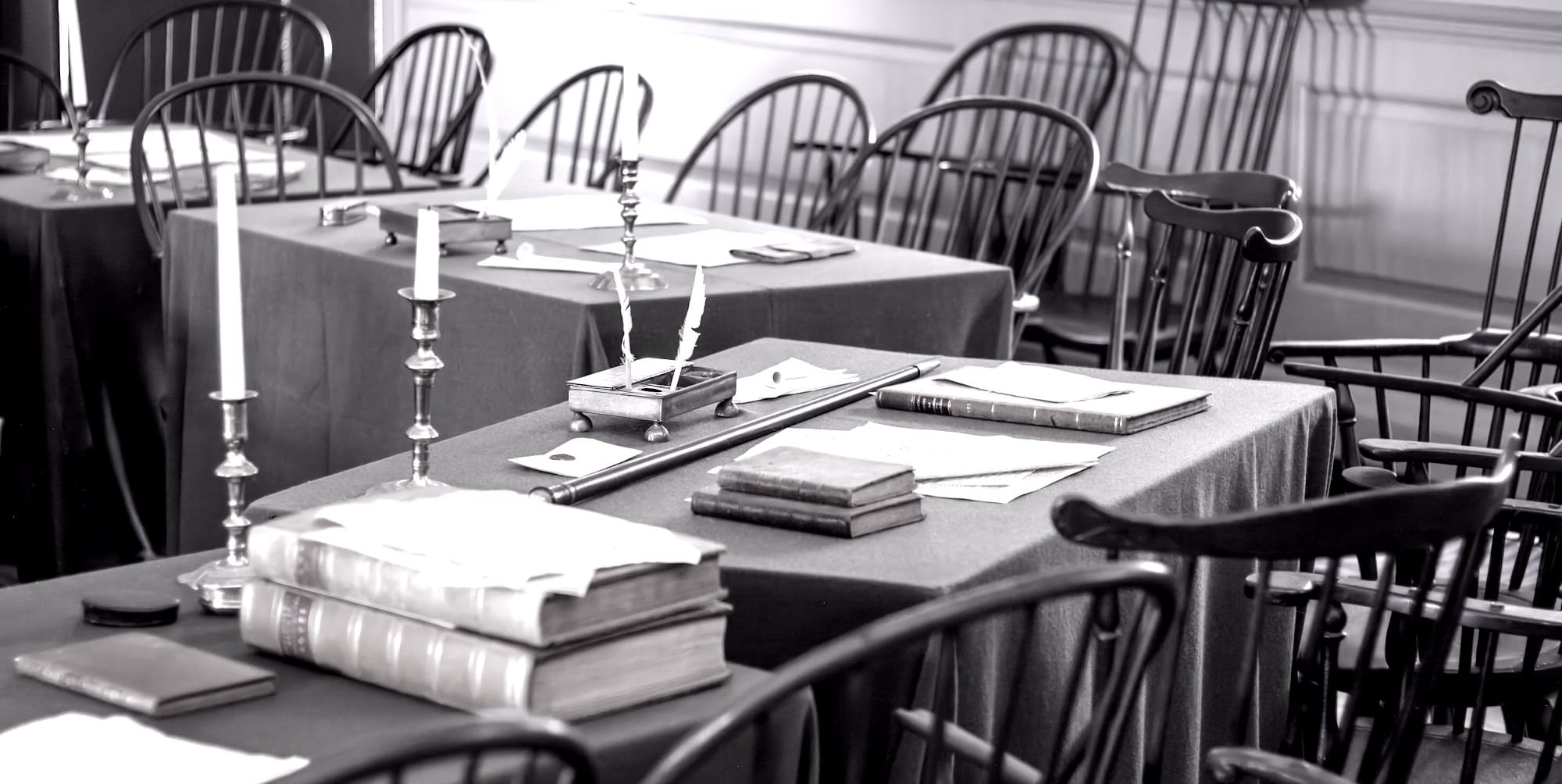 A table with many books and candles on it