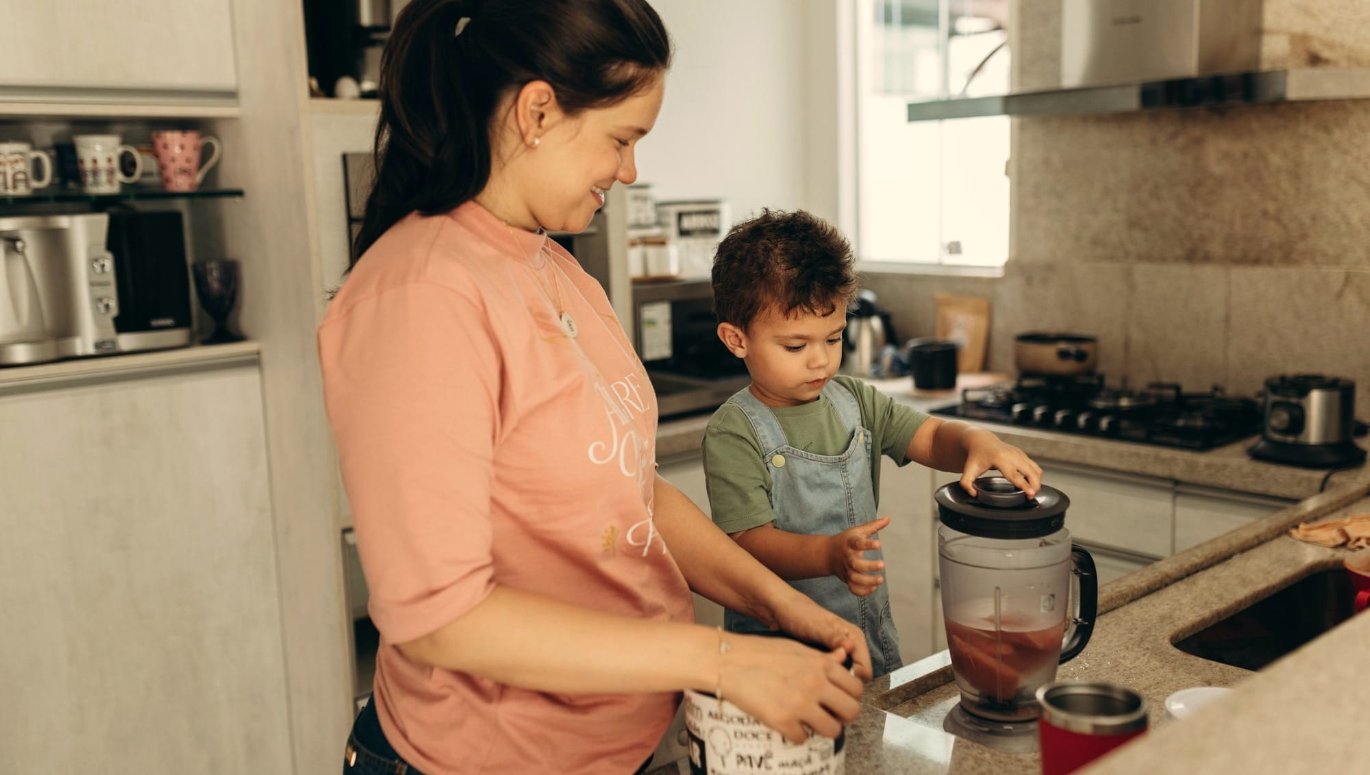 a woman and a child are in the kitchen