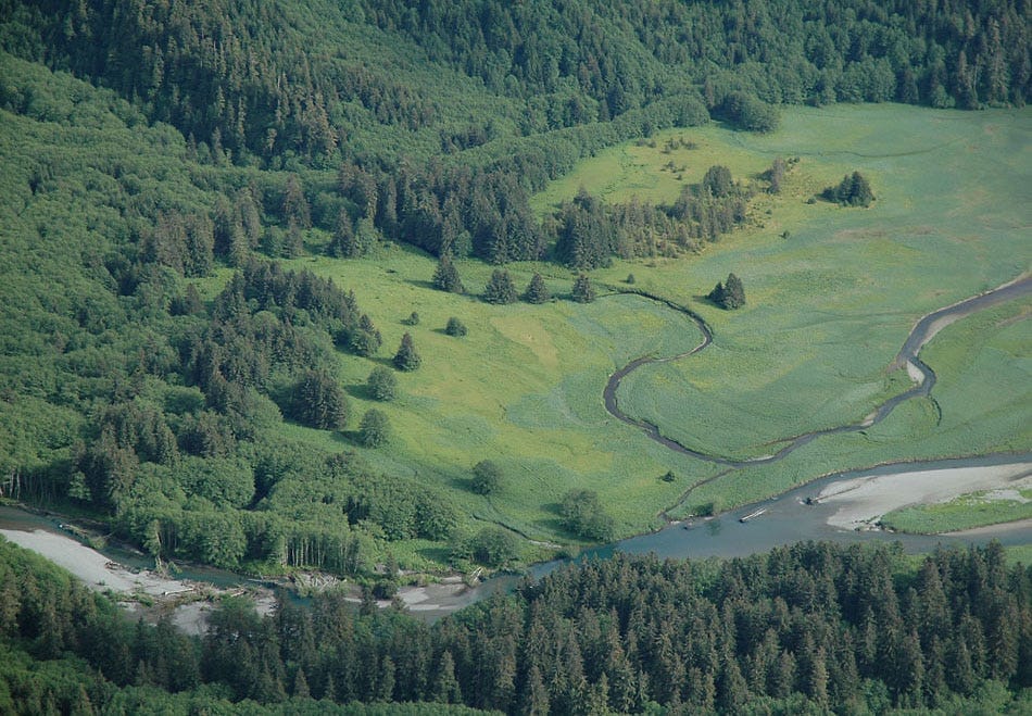 Looking down at the mouth of a river from a mountain ridge.