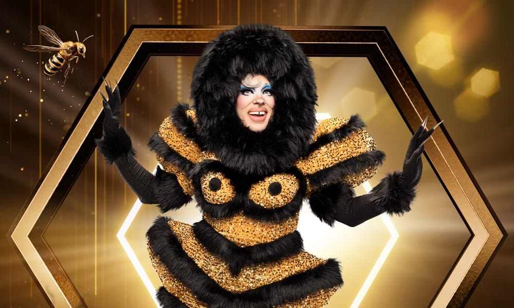 Uma dressed in black and gold like a fuzzy bumblebee