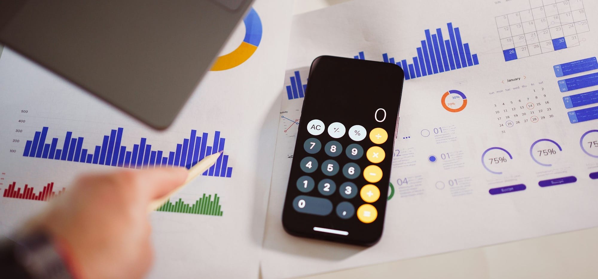a calculator sitting on top of a table next to a laptop