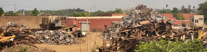 Heaps of rusted metal in a scrapyard. 