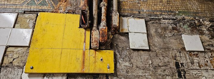 Rotting subway station walls, corroded electrical wiring, falling tiles exposing filthy walls. 