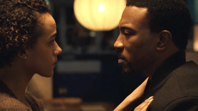 Two people face each other closely in a warm, dimly lit scene from Echoes.