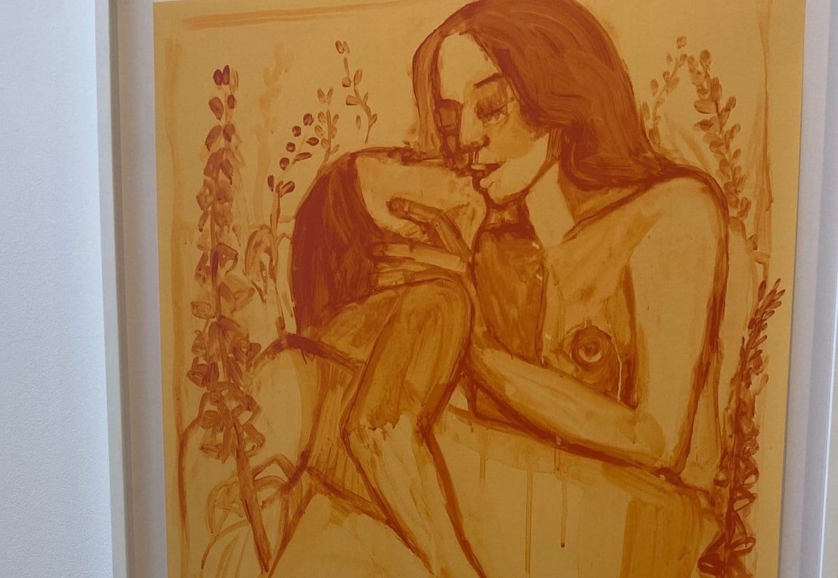Monochromatic painting in warm amber tones of a nude woman holding a small dog, surrounded by floral stems.