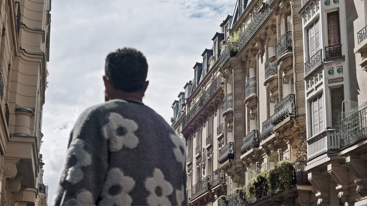 One of the actors representing the Palestinian interviewees looks down a Parisian street towards the sky.