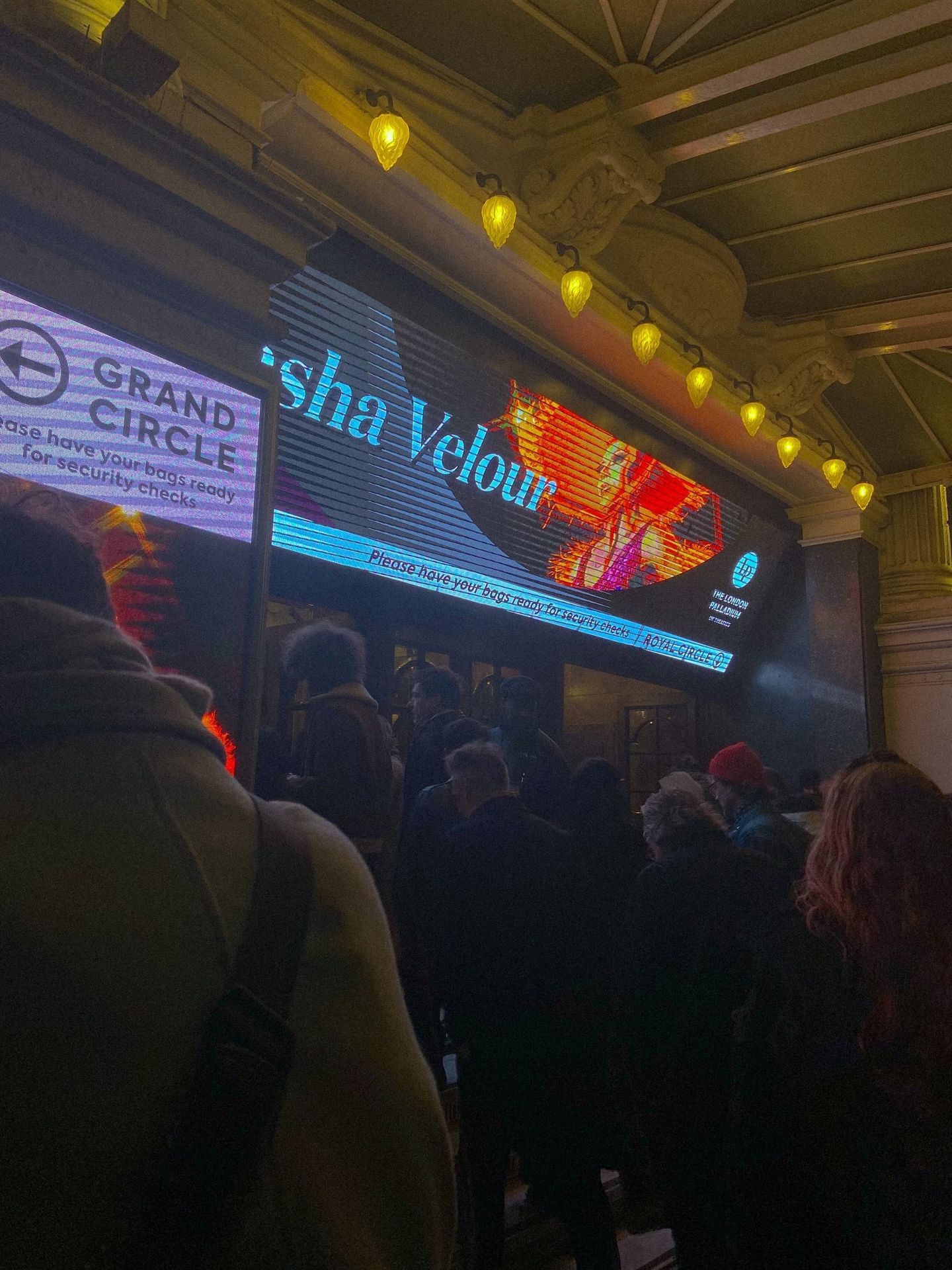 Crowd entering The London Palladium at night for a Sasha Velour show, with illuminated marquee and "Grand Circle" sign.