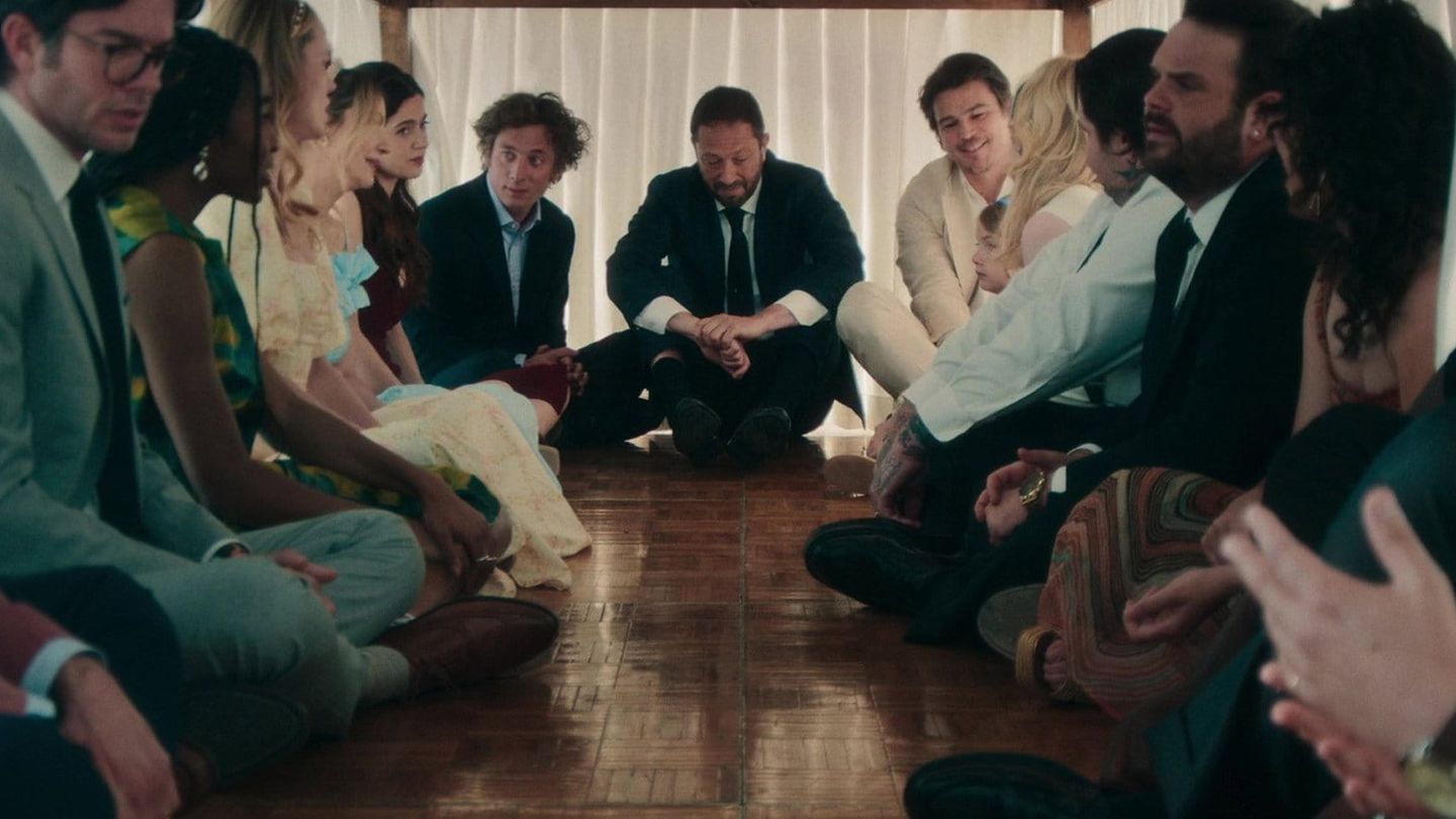 The Bear final-season ensemble sits together in a tense group scene.