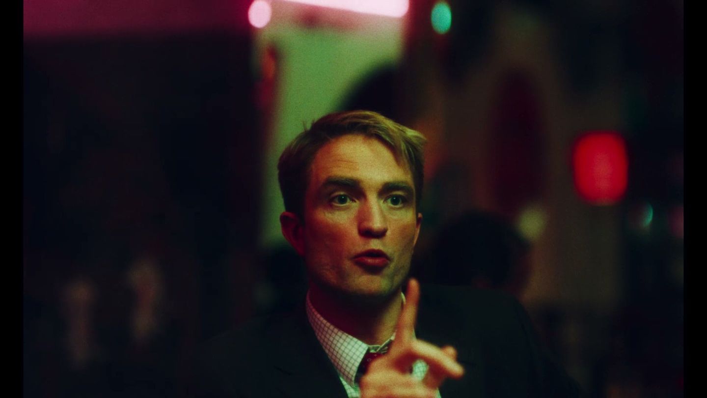 Robert Pattinson in a neon-lit still from the official Primetime trailer.
