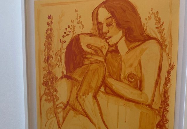 Monochromatic painting in warm amber tones of a nude woman holding a small dog, surrounded by floral stems.