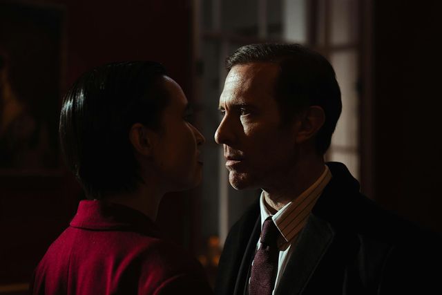 Two figures in a red-lit gothic scene from the short film Red City.