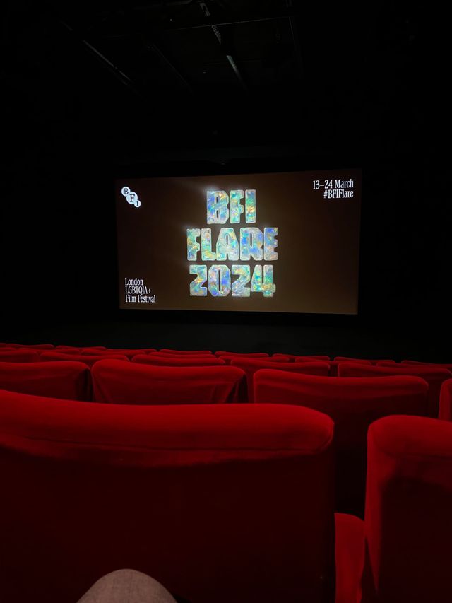 Cinema interior with red velvet seats facing a screen displaying "BFI Flare 2024" London LGBTQIA+ Film Festival, 13–24 March.