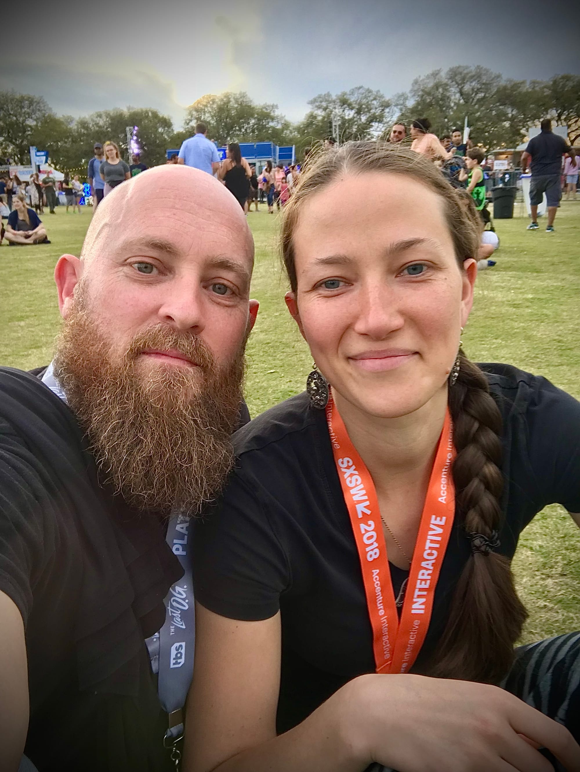 Husband and Wife Sitting in Field at SXSW 2018