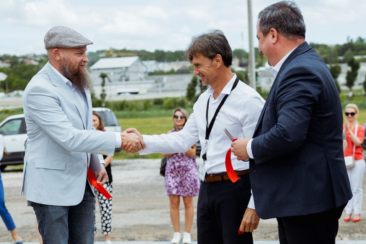 Two Men Shaking Hands at a Ribbon-Cutting Ceremony