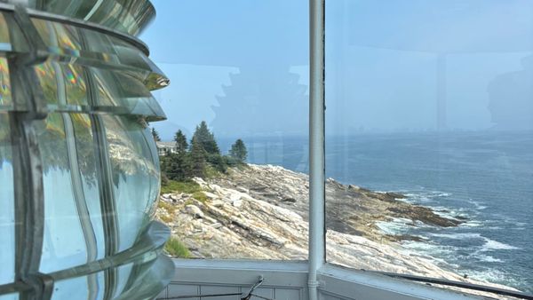From the top of Pemaquid Point Lighthouse overlooking the ragged Maine Coastline with waves crashing.